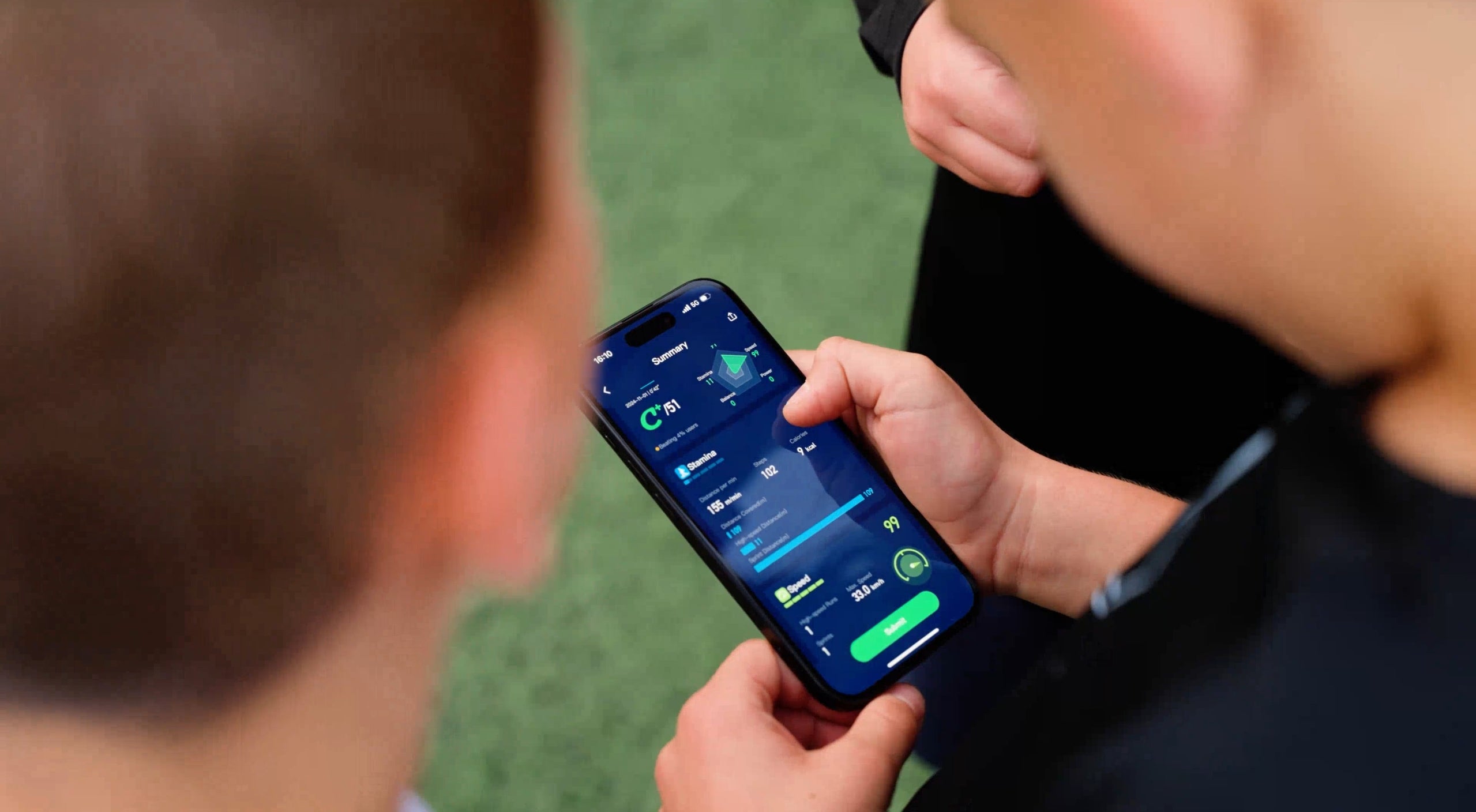 Soccer player showing soccer tracking stats with others.
