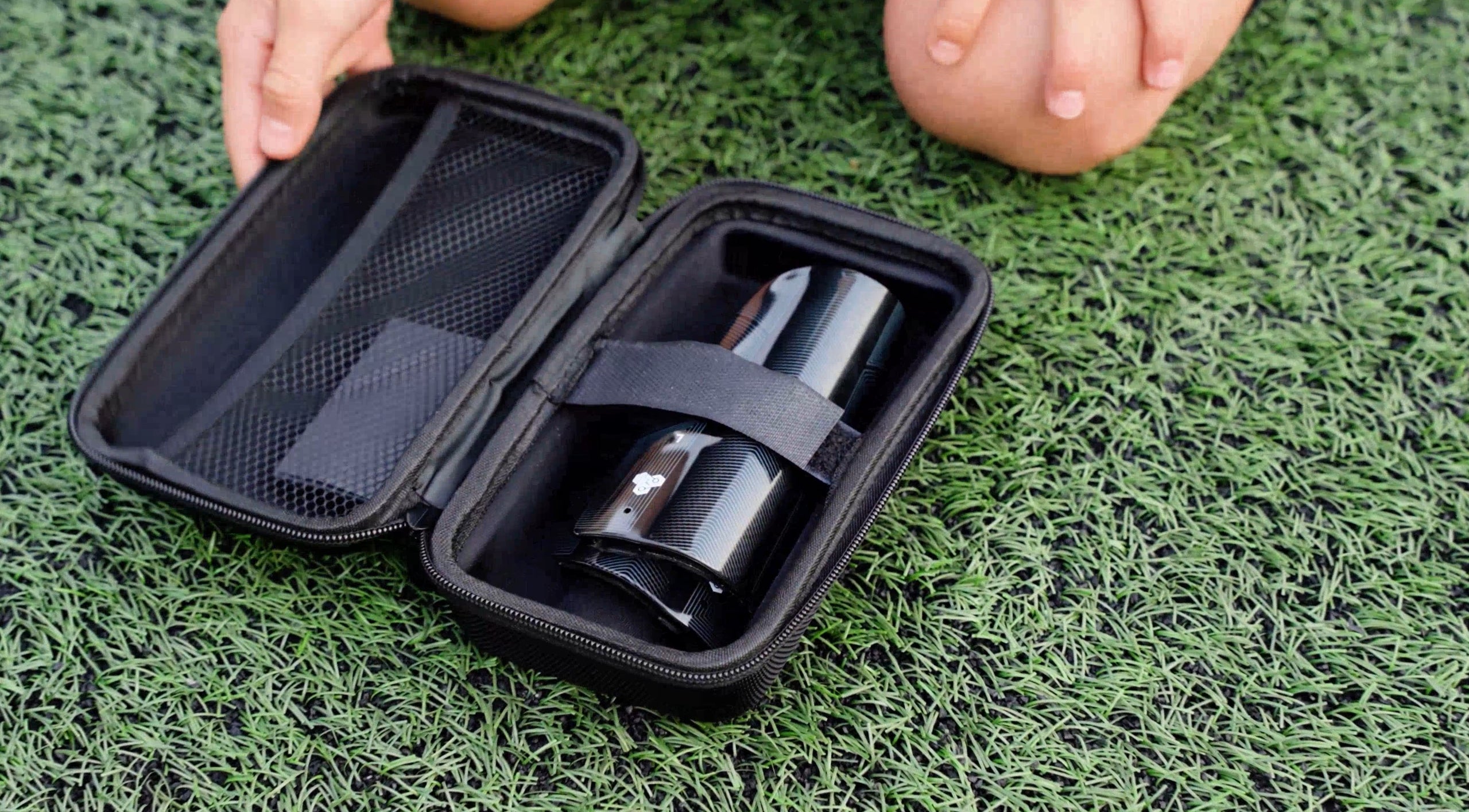 Player open up a box of smart shin guards with soccer trackers.