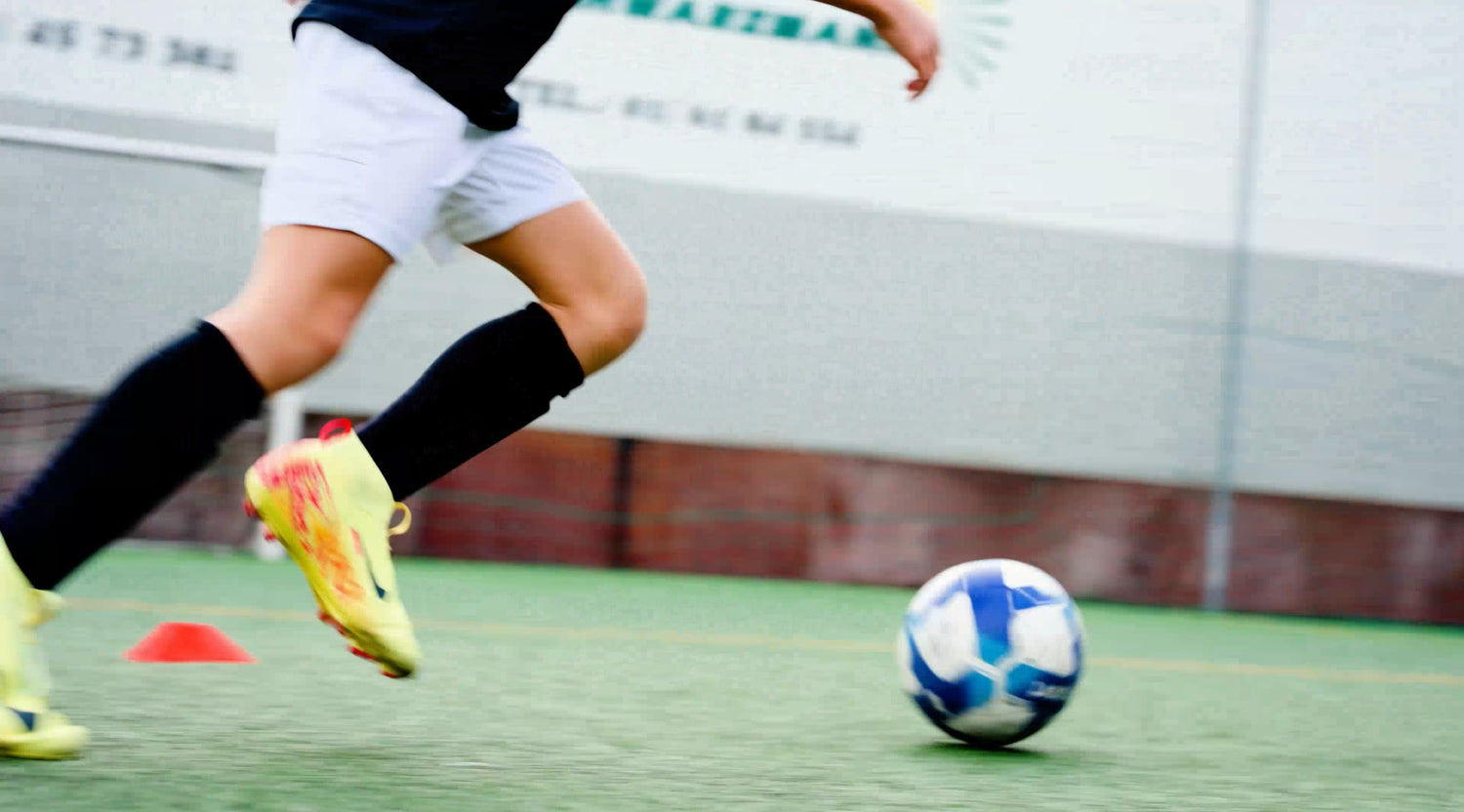 Player wearing smart shin guards in a soccer training session.